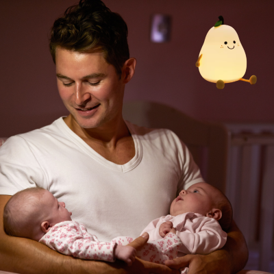 Dans une chambre papa attentionné regarde c'est deux jumeaux grùce veilleuse bébé.